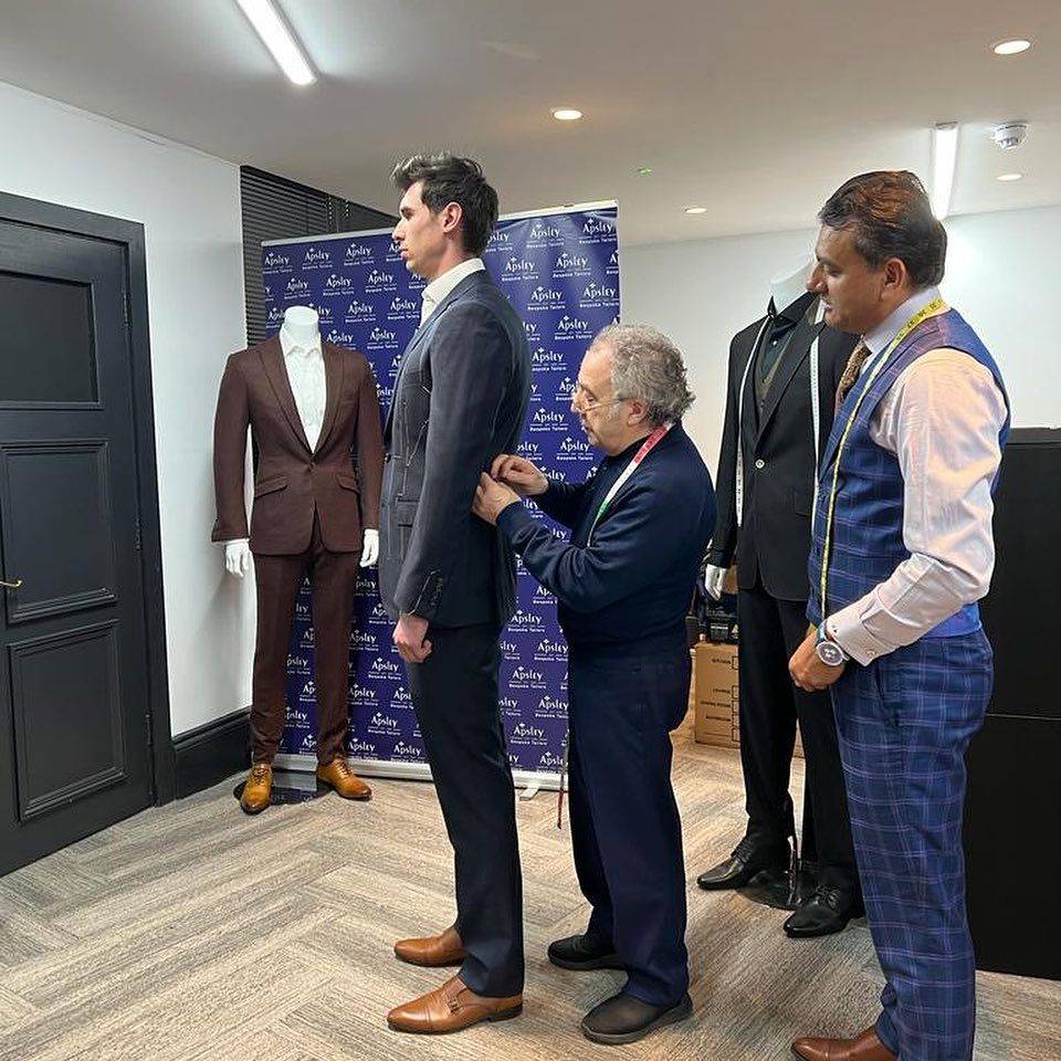 Expert Suit Fitting Process at Apsley Tailors London Professional tailor performing detailed measurements for a bespoke suit fitting