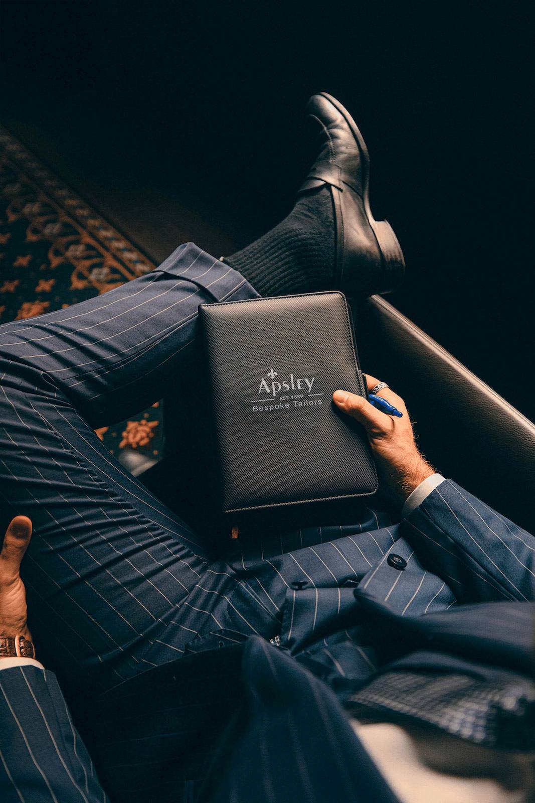 Quality Control in Bespoke Suit Manufacturing Detailed inspection of hand-stitched elements in bespoke suit construction